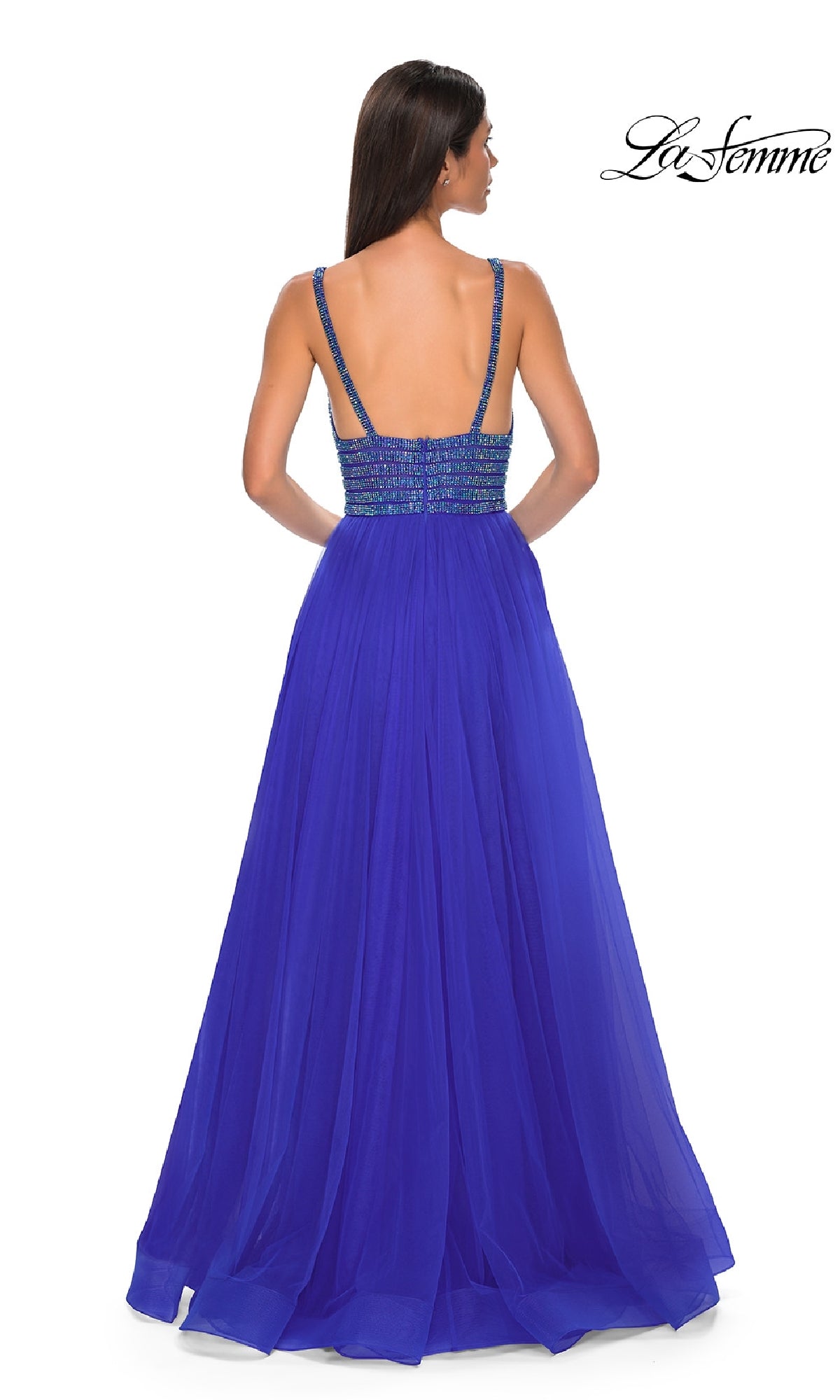 A woman wearing the La Femme 32714 rhinestone-bodice prom ball gown, a sleeveless, royal blue, floor-length a-line dress with an open back, stands facing away as the La Femme logo appears in the top right corner.